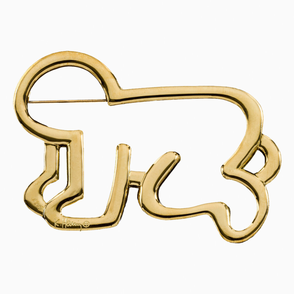 Untitled (Baby Pin) (1989) by Keith Haring, a bold, graphic composition in Haring’s signature style featuring a simplified, radiant baby figure in pin form, rendered in 18 carat gold lines