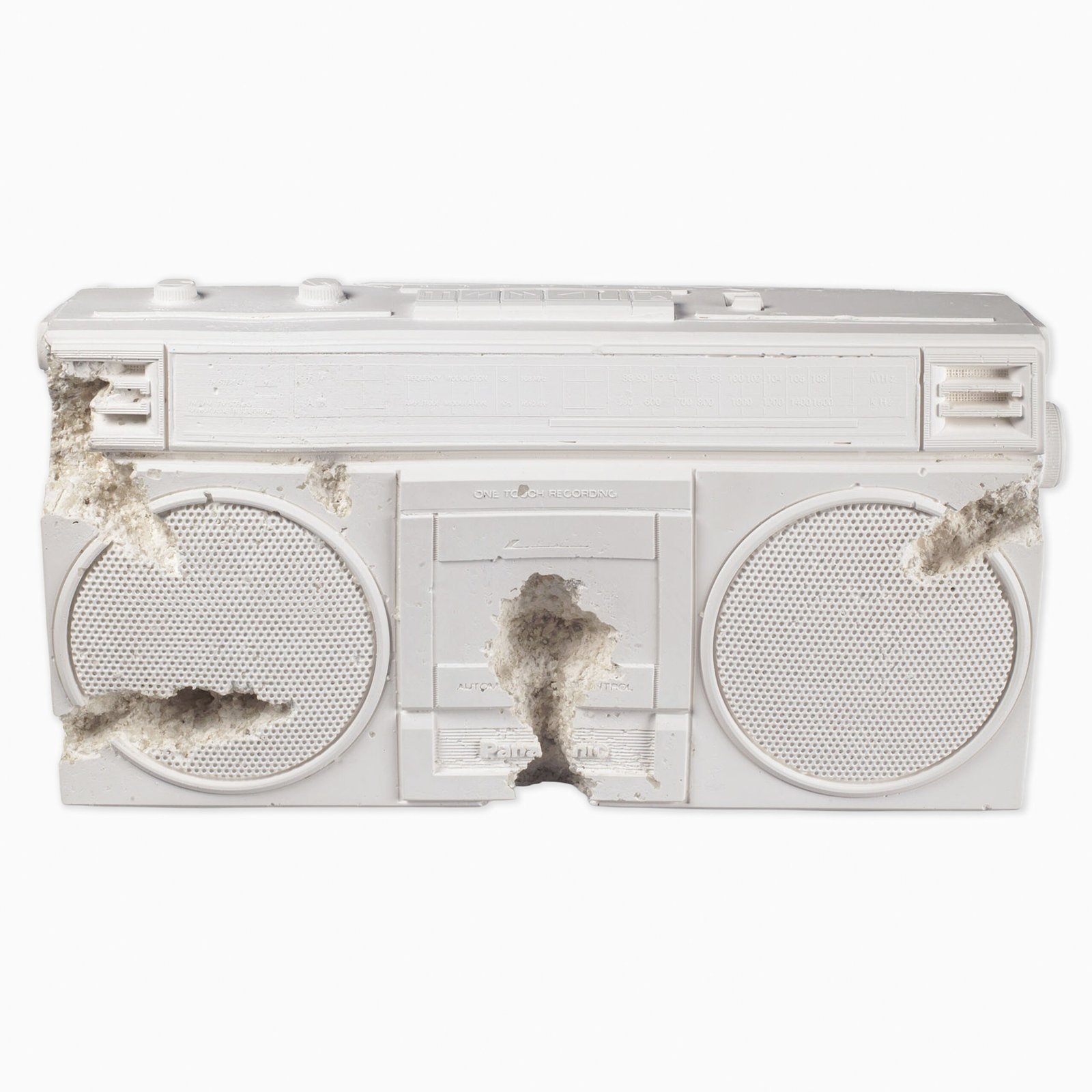 Future Relic 08 – Radio (2017) by Daniel Arsham, a sculptural depiction of a vintage radio cast in plaster and embedded with crushed glass, combining a familiar retro object with a weathered, archaeological appearance. The pale surface and crystalline fragments suggest an artefact preserved from a distant future.