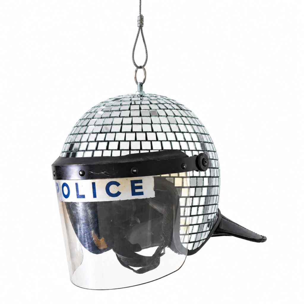 Met Ball (2019) by Banksy, a reclaimed police riot helmet covered with mirrored tiles, transforming protective equipment into a reflective sculptural artwork.